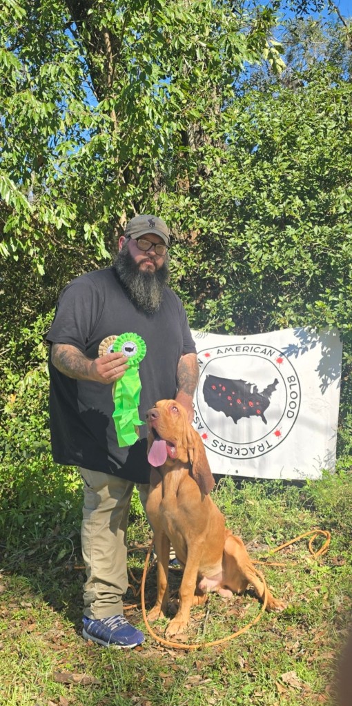 Gus the tracking dog receives his ABT and UBT certifications. The photos show Gus and his handler participating in tests to track simulated wounded game and earn their credentials for recovering animals.